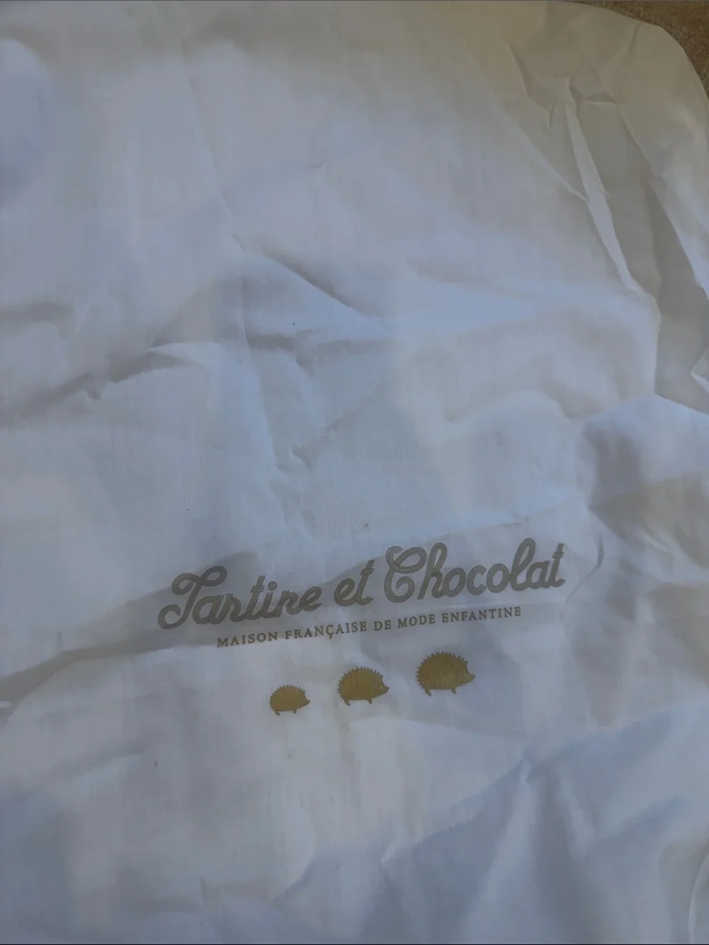 Tartine et Chocolat White Garment Bag with Gold Hedgehog Accents